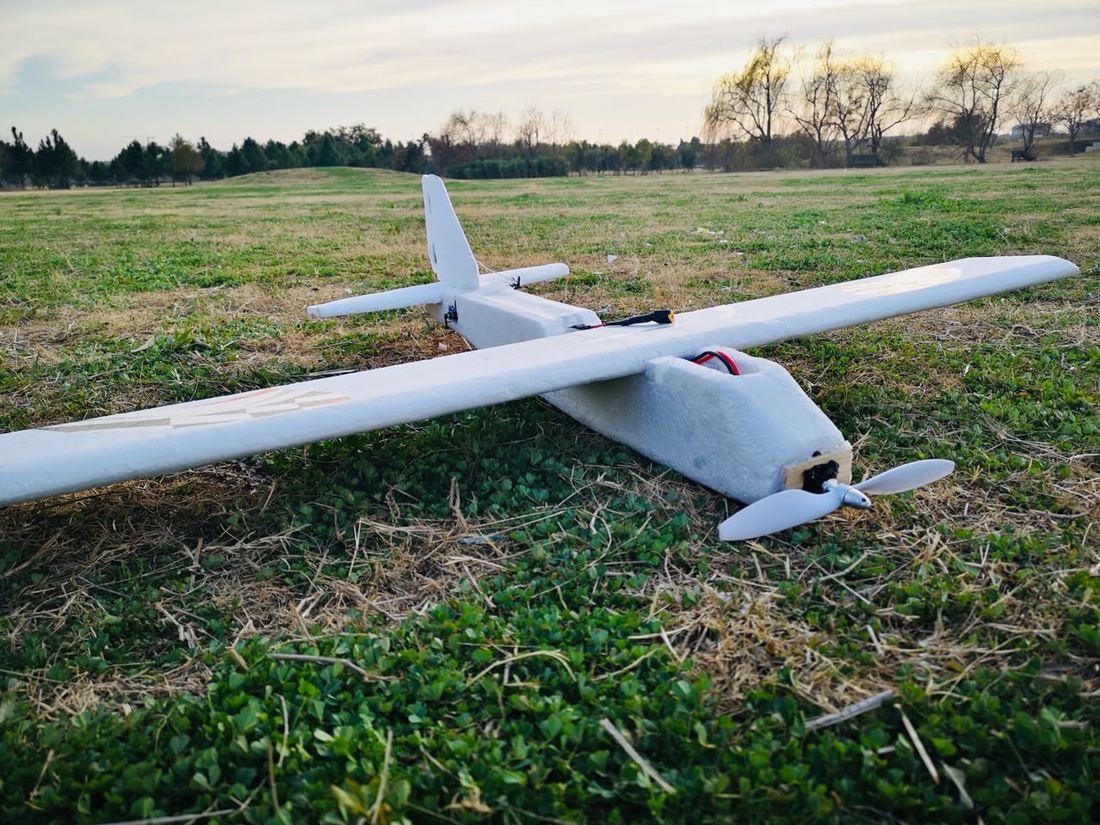Fixed-wing UAV on grass before a test flight.